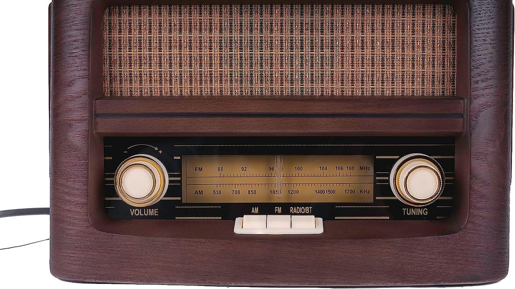 Vintage radio front view with speaker grille, AM/FM scale, and volume tuning knobs