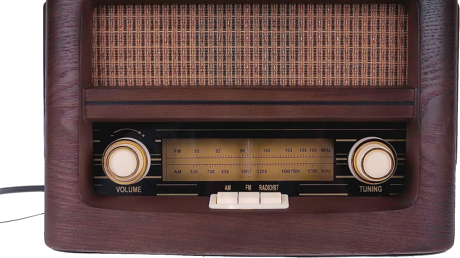Vintage radio front view with speaker grille, AM/FM scale, and volume tuning knobs