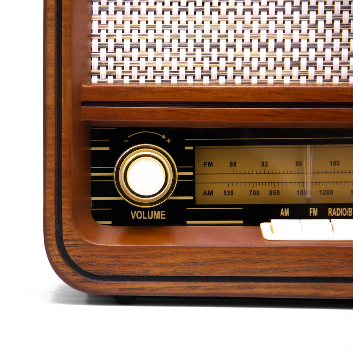 Wooden radio front corner with glowing volume knob and station dial
