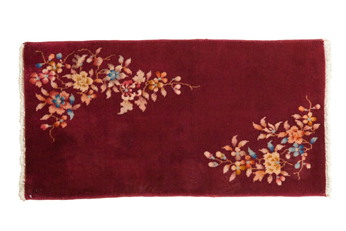 Vintage art deco rug runner in deep red with multicolor floral motifs and fringe edges
